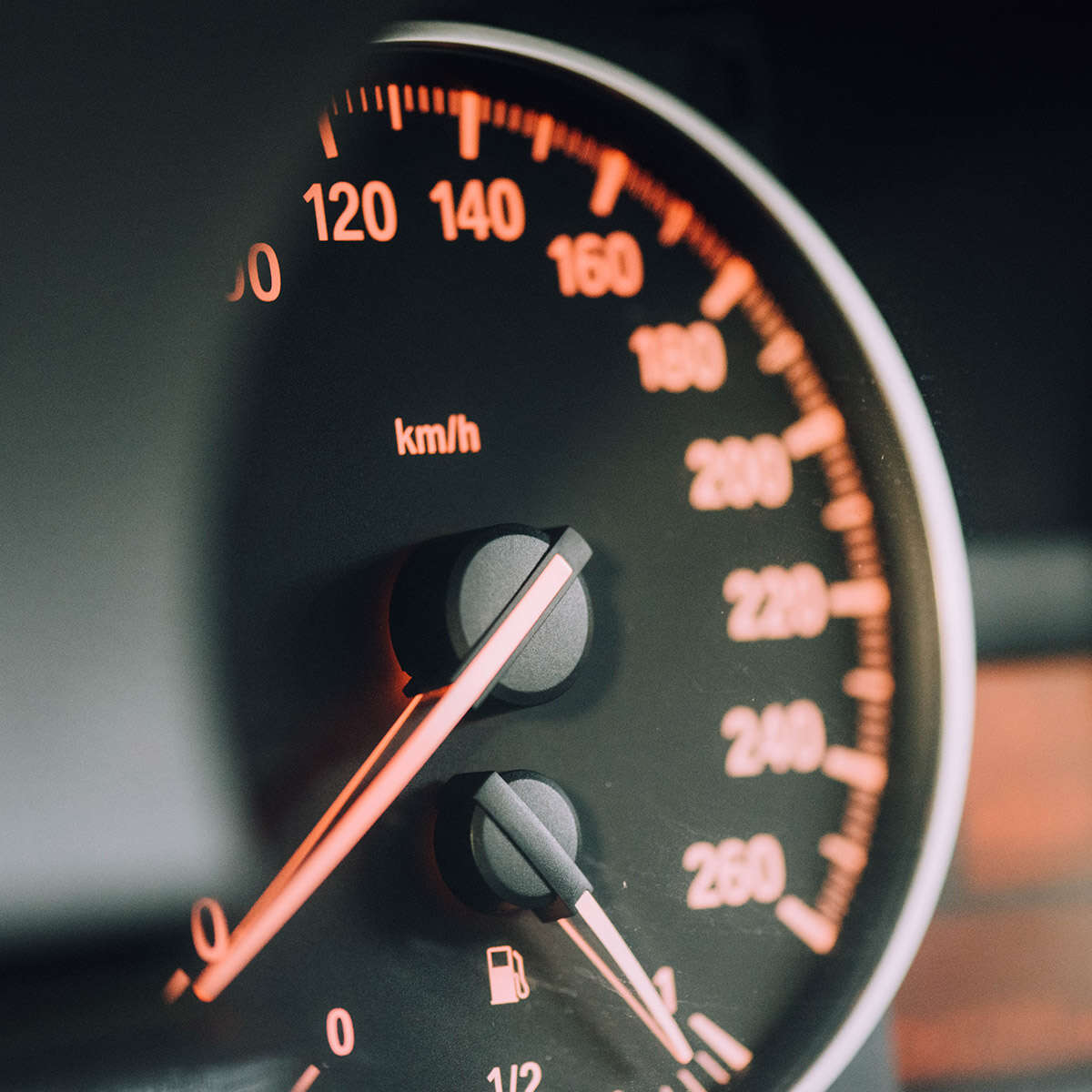 Close-up of a car speedometer showing speeds up to 260 km/h.